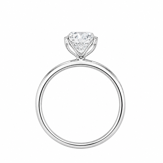A classic solitaire engagement ring featuring a brilliant round-cut diamond set in a polished white gold metal band, shown against a plain white background.