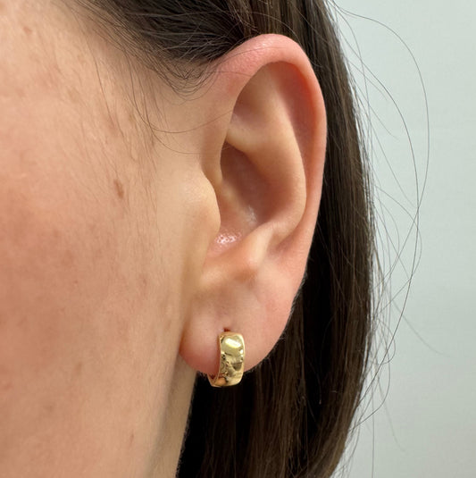 Gold Huggie Earrings Close to ear on an earlobe