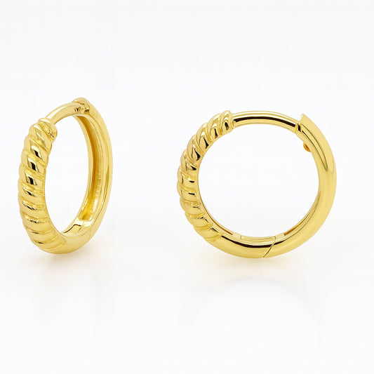 Gold hoop earrings on a white background
