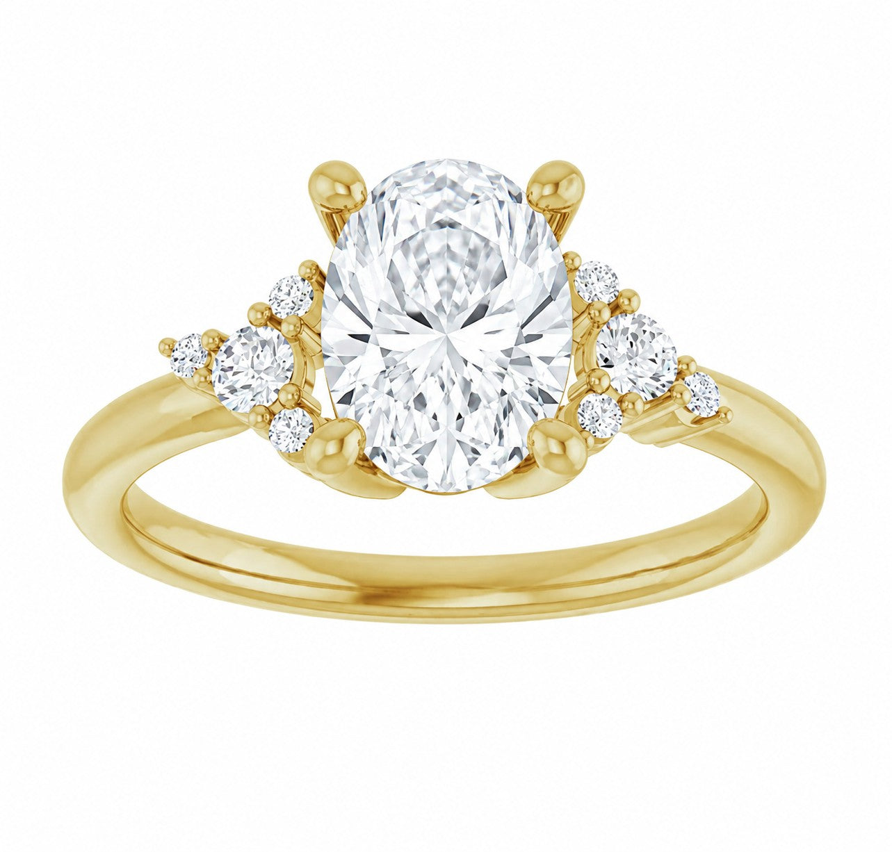 Gold engagement ring with a large oval cut diamond and smaller diamonds on a white background