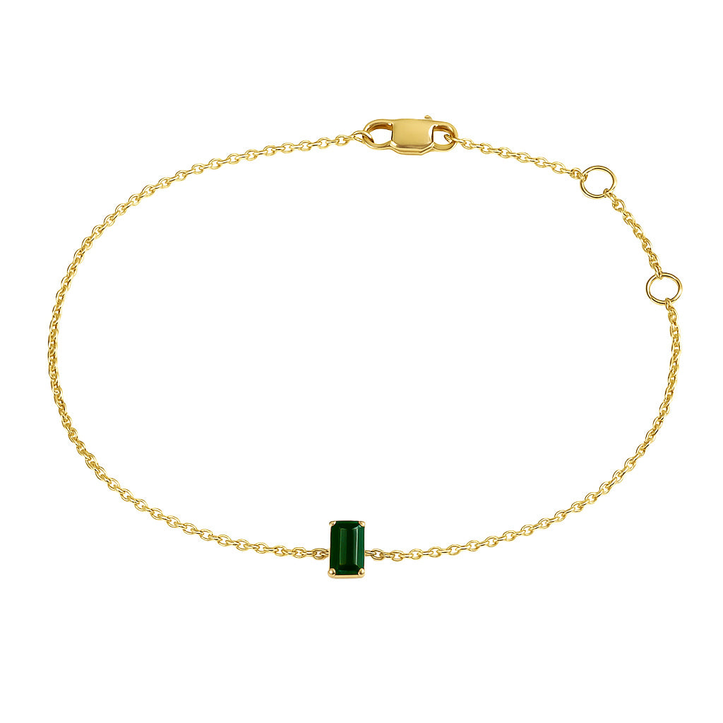 Gold bracelet with a Natural green emerald gemstone on a white background