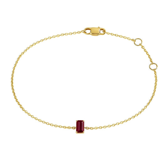 Gold bracelet with a red natural ruby gemstone on a white background