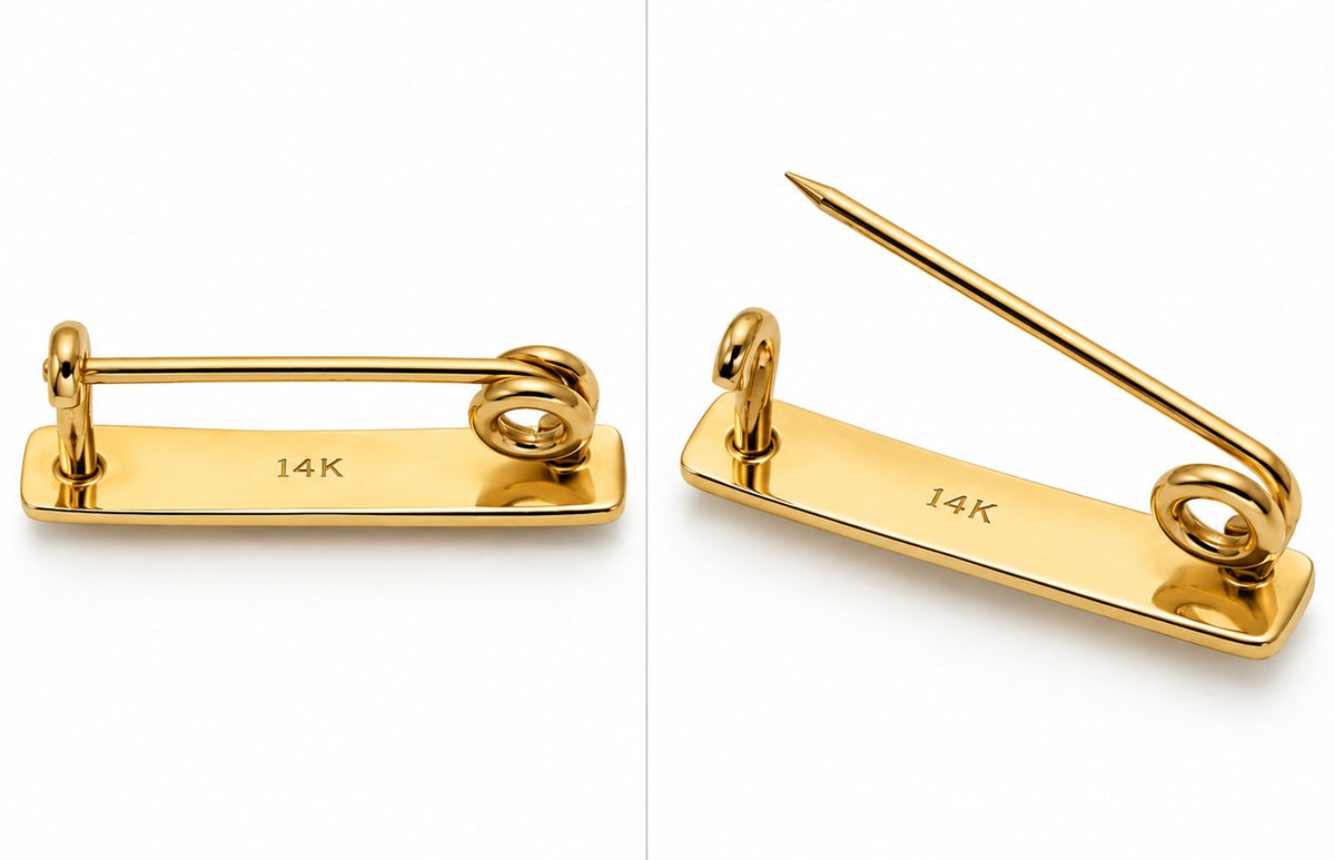 A gold-tone 14K pinback brooch shown from two angles on a white background, highlighting the flat backplate engraved with '14K' and the sharp pointed prong.