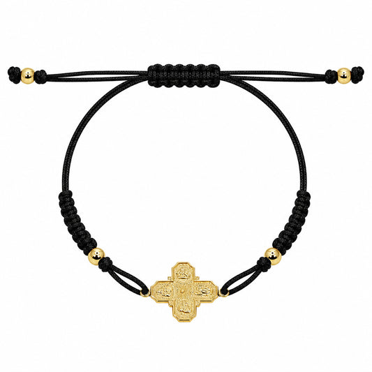 A 14k gold 4-way cross pendant on a black macrame bracelet with gold-filled bead accents.