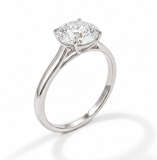 A classic solitaire engagement ring featuring a round brilliant-cut diamond set in a polished white gold  shown on a clean white background with a soft shadow