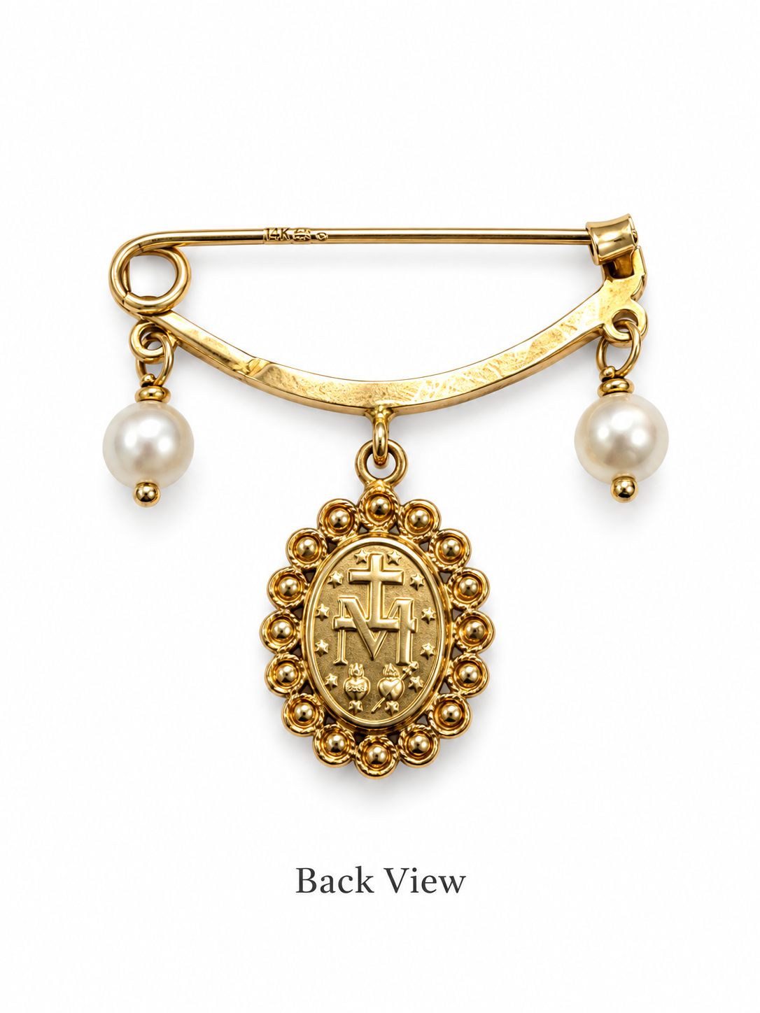 A gold safety pin brooch with two dangling pearl beads and a central oval religious medallion featuring a cross and monogram, shown on a white background with the text 'Back View' below.