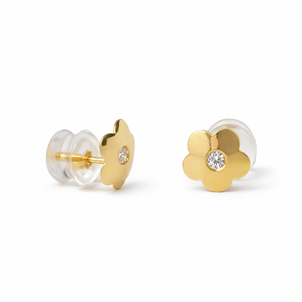 Gold flower-shaped earrings with cubic zirconia centers on a white background