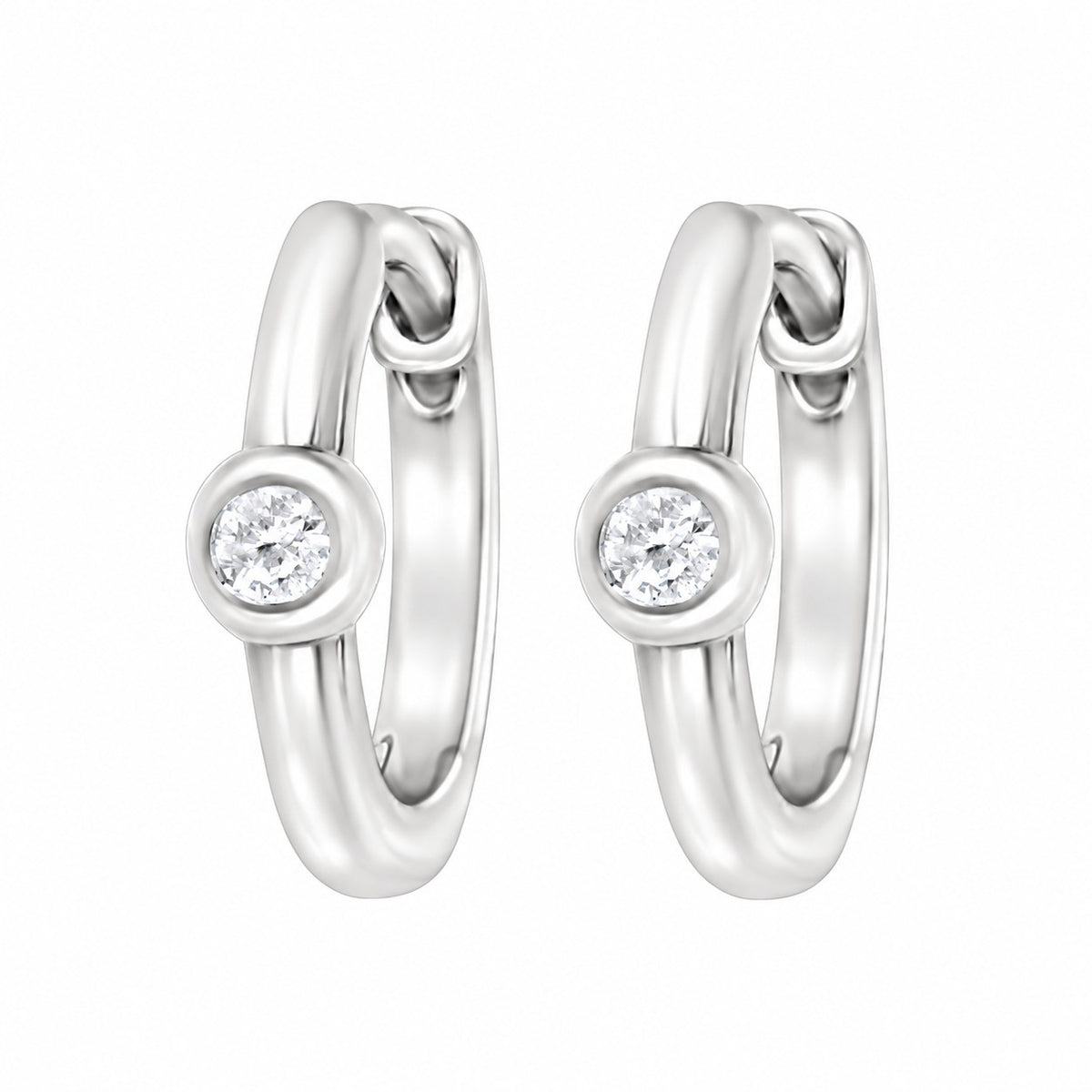 A pair of polished white gold huggie hoop earrings, each featuring a bezel-set round diamond gemstone, shown against a plain white background.