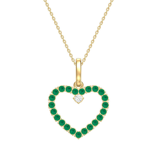 Heart-shaped pendant with green emerald gemstones and a diamond, on a gold chain against a white background.