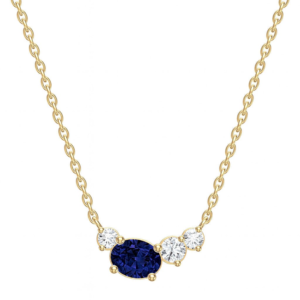 Gold necklace with a blue sapphire gemstone and three diamonds on a white background