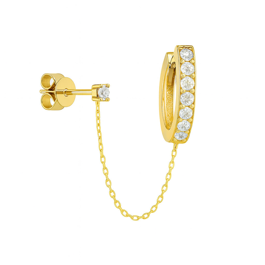 Yellow Gold diamond hoop huggie earring and diamond stud attached by chain on a white background