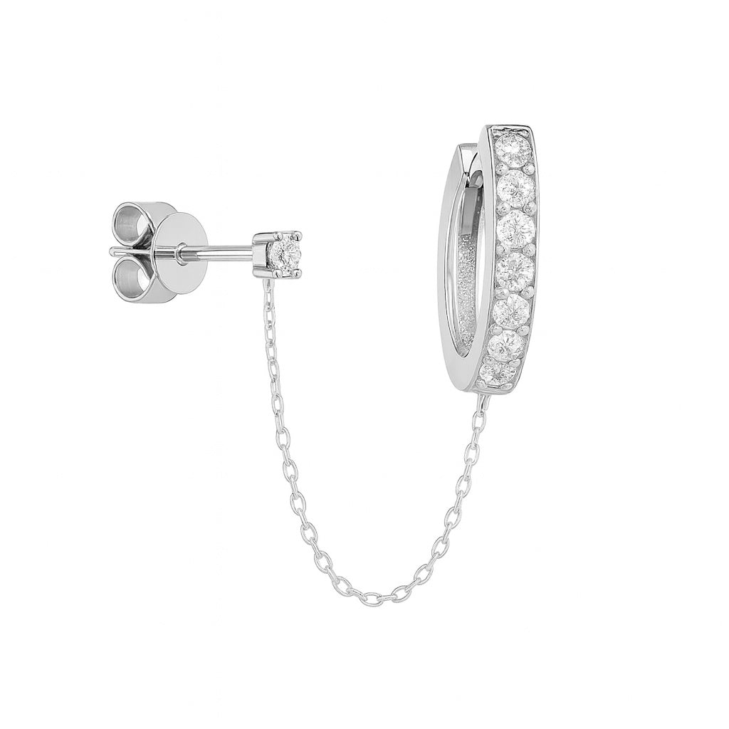 White Gold diamond hoop huggie earring and diamond stud attached by chain on a white background