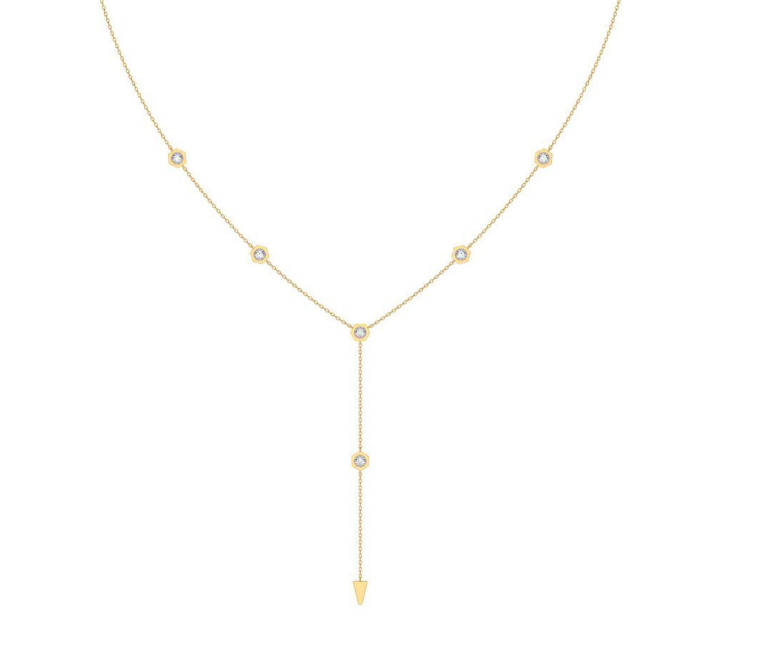 A delicate gold Y-necklace featuring five small round bezel-set diamond stones along the chain and a longer drop pendant ending in a pointed gold tip, shown on a plain white background.
