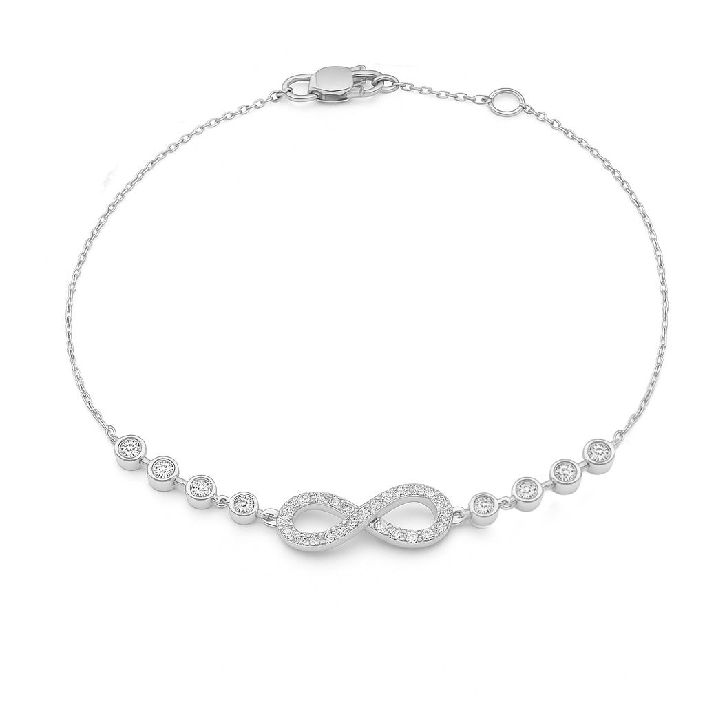 A 14K white gold bracelet featuring an infinity symbol with pave and bezel-set diamonds and a cable chain.