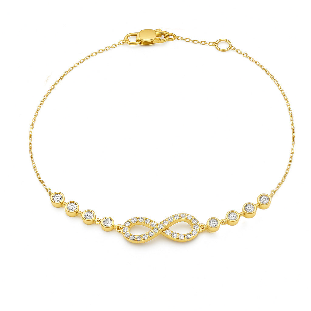 A 14K yellow gold bracelet featuring an infinity symbol with pave and bezel-set diamonds and a cable chain.