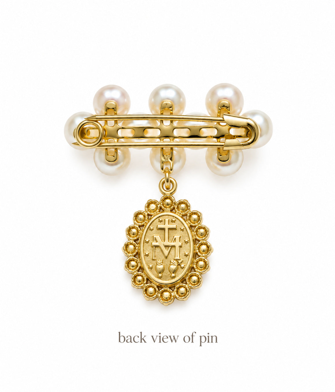 Back view of baby pin showing the back view with a dangling oval medallion and three pearl-like beads on a white background.