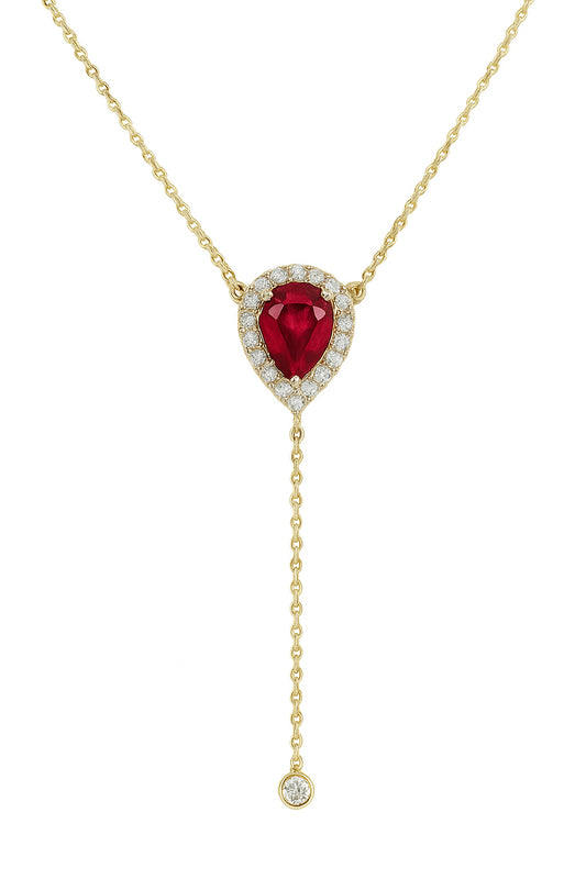 Gold necklace with a red gemstone pendant on a white background