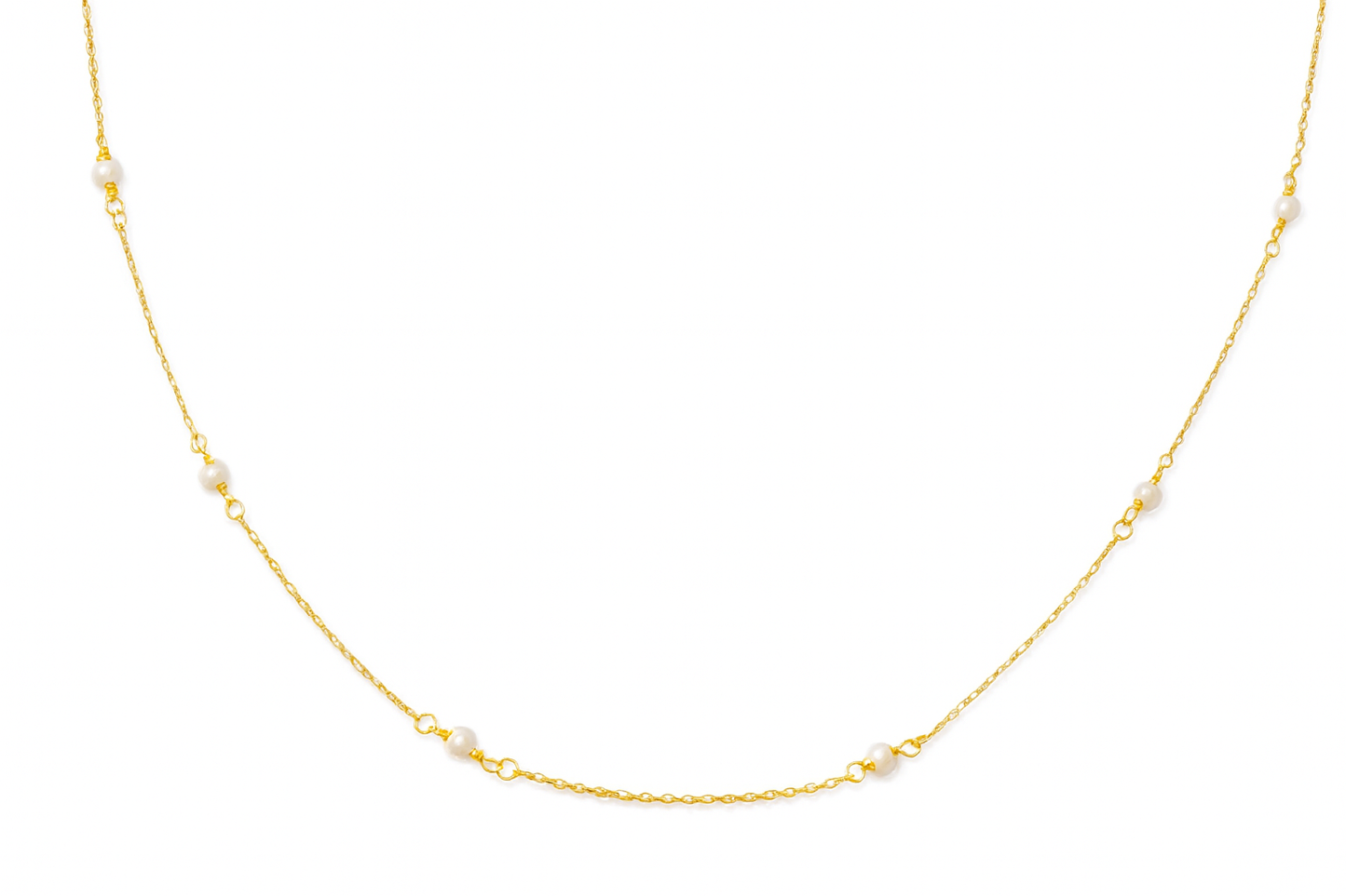 Gold necklace with small pearls on a white background