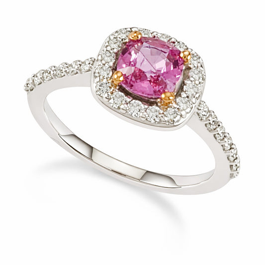 A cushion cut pink sapphire gemstone ring with a halo of white diamonds set in 18K white gold.