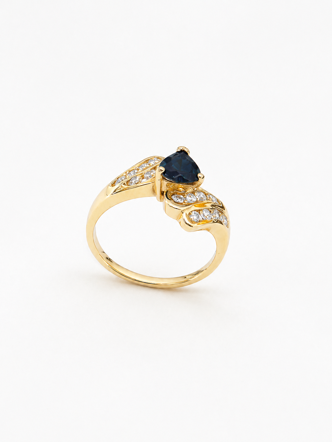 14K yellow Gold ring with a central blue sapphire gemstone and diamond accents on a white background