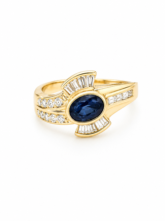 14K Gold ring with a blue sapphire gemstone and diamond accents on a white background