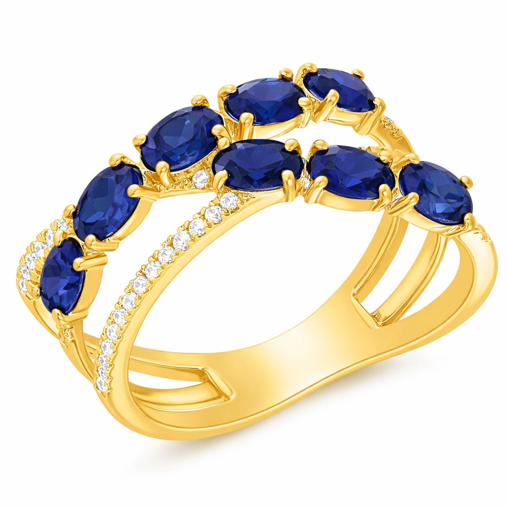 Gold ring with blue sapphire gemstones on a white background