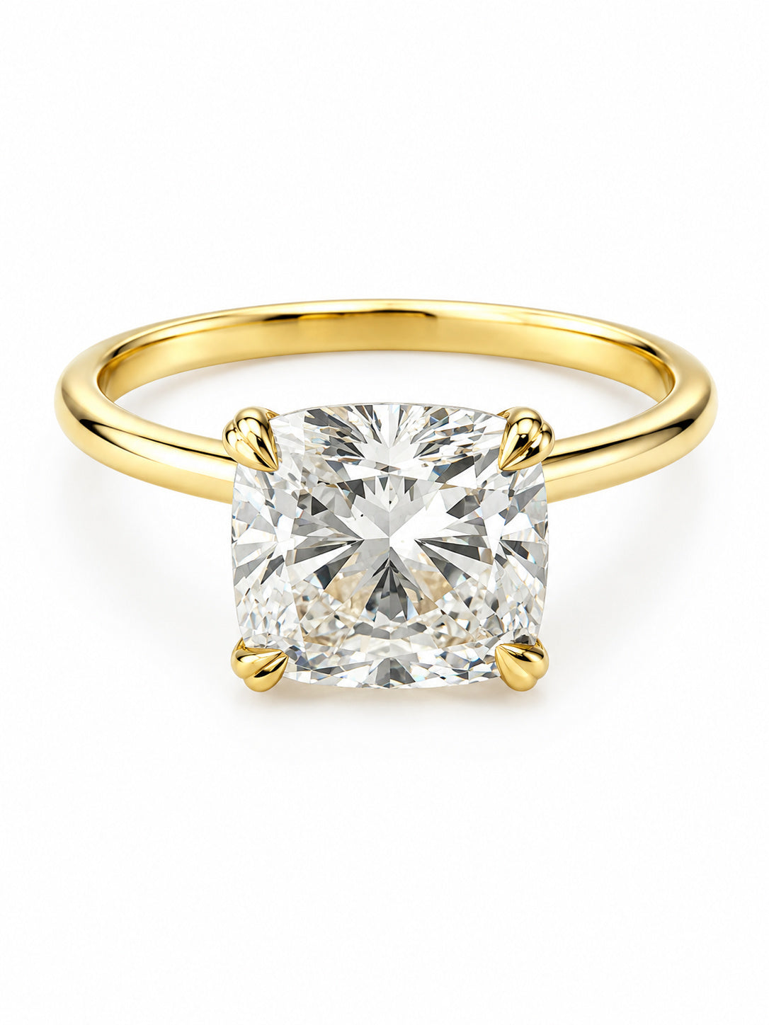 A cushion-cut diamond engagement ring with a polished yellow gold band, shown on a clean white background.