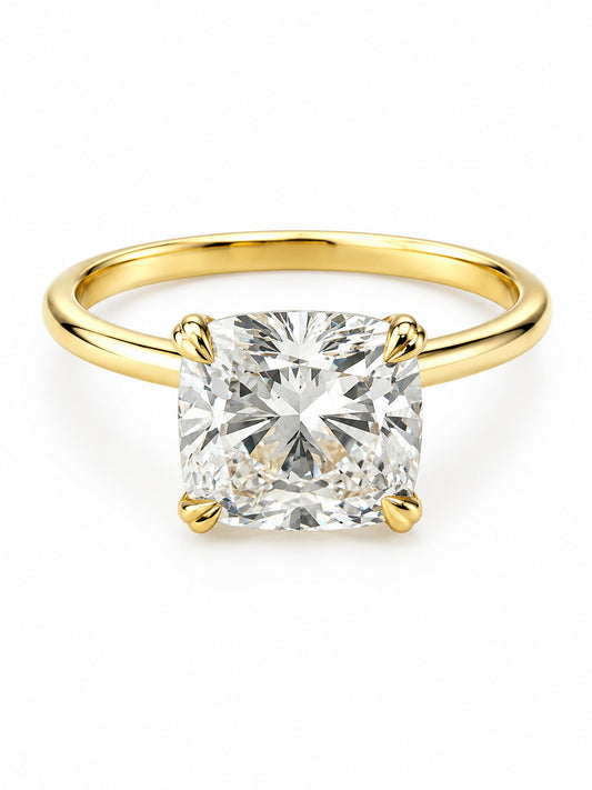 A cushion-cut diamond engagement ring with a polished yellow gold band, shown on a clean white background.
