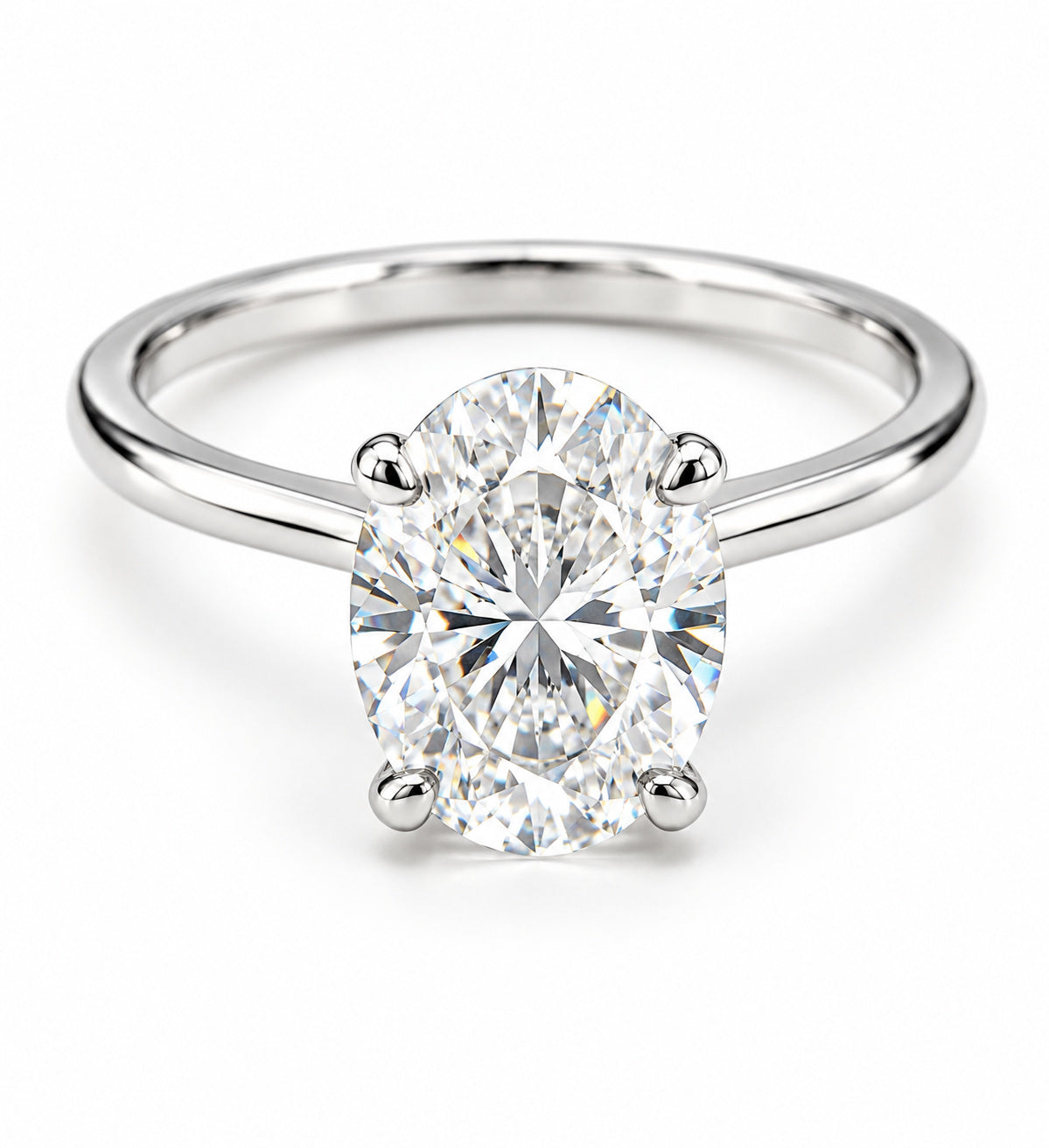 An oval-cut diamond solitaire ring in a four-prong setting on a polished white gold band, shown against a clean white background.