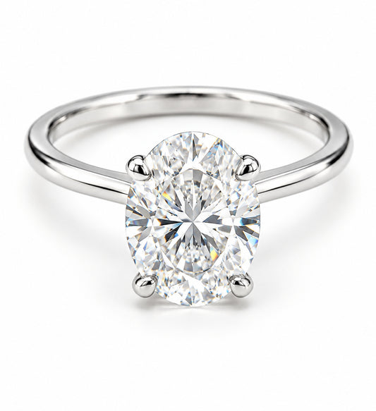 An oval-cut diamond solitaire ring in a four-prong setting on a polished white gold band, shown against a clean white background.