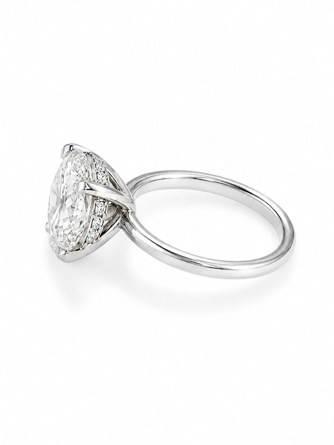 A white gold  hidden halo diamond engagement ring featuring a large round-cut center diamond surrounded by smaller diamonds, set on a polished band, shown on a clean white background.