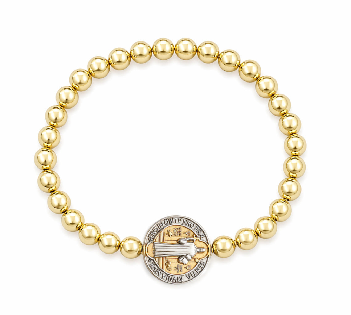 Gold beaded bracelet with a Saint Benedict 14K two tone medal charm on a white background