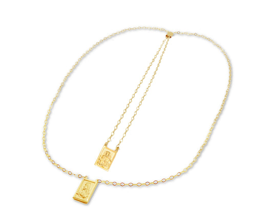 A 14K gold double scapular necklace with an adjustable chain and two medals, one depicting the Virgin Mount Carmel and the Sacred Heart of Jesus, the other with a gold cross.
