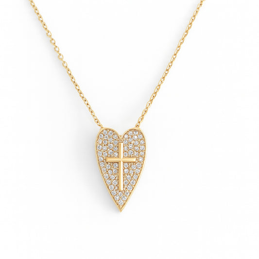 Gold necklace with a heart-shaped pendant featuring a cross design on a white background