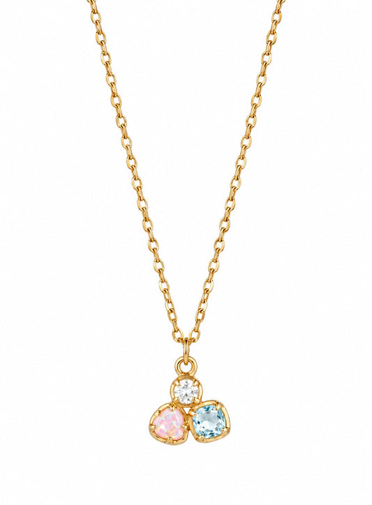 Gold necklace with three colorful gemstones on a white background