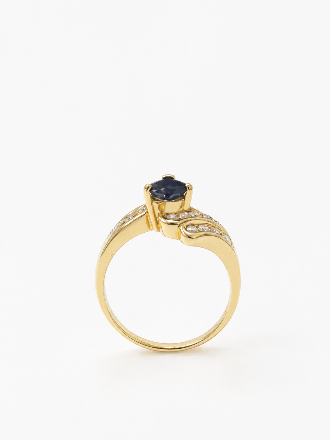 14K yellow Gold ring with a blue sapphire gemstone and diamond accents on a white background