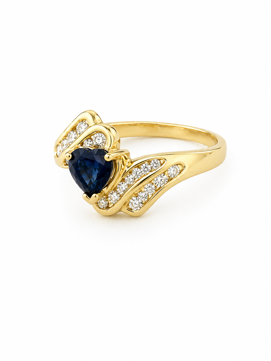 14K Gold ring with a heart-shaped blue sapphire gemstone and diamonds angled on a white background