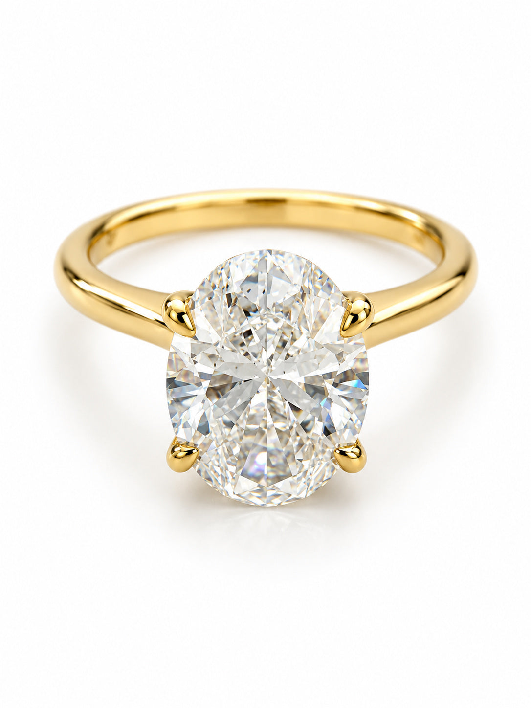 A yellow gold solitaire engagement ring featuring a large oval-cut diamond in a four-prong setting, shown on a clean white background.