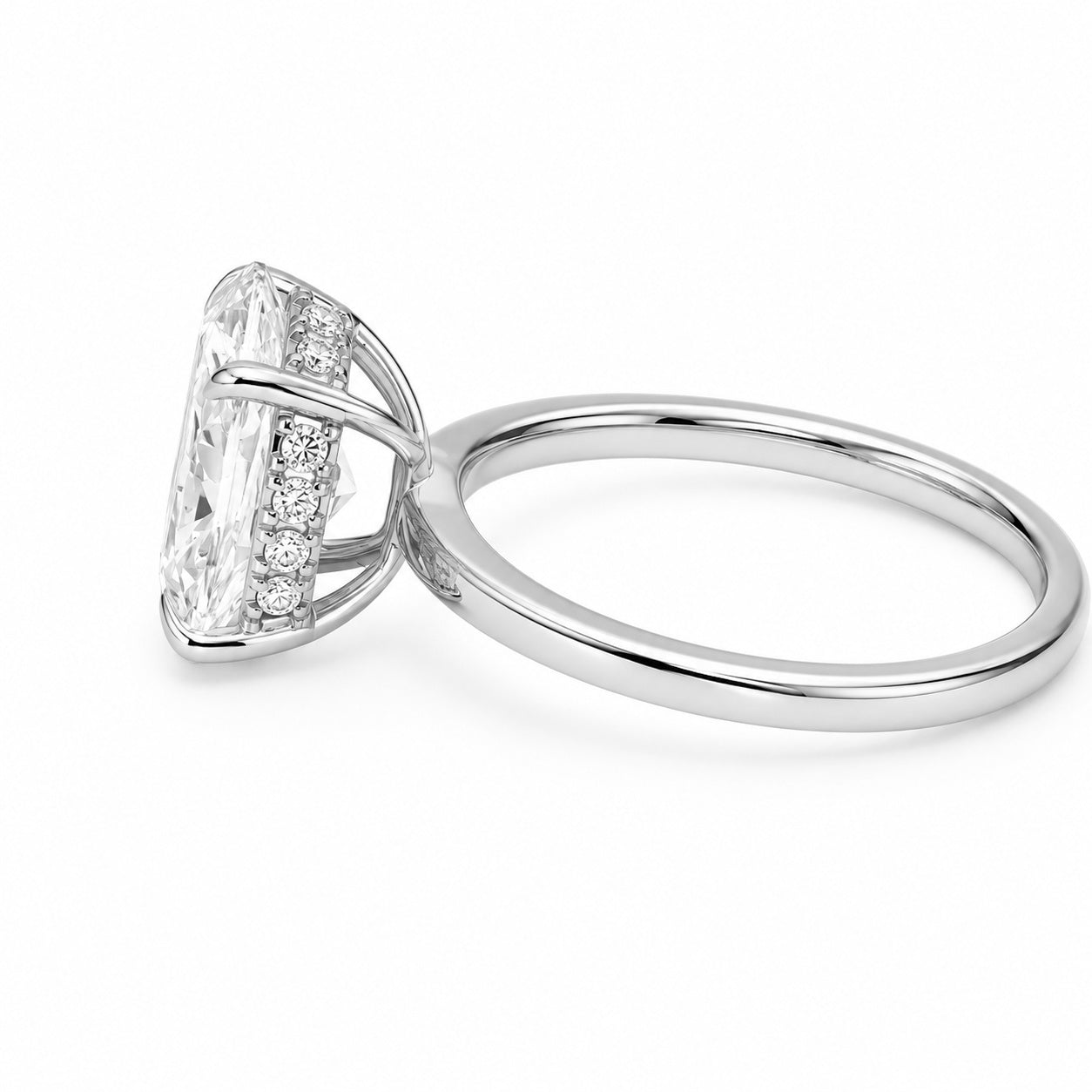 A white gold diamond ring featuring a large oval-cut center diamond and a hidden halo of smaller round diamonds, shown on a clean white background.