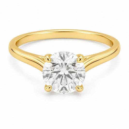 A classic solitaire engagement ring featuring a round brilliant-cut diamond set in a yellow gold four-prong band, shown on a clean white background.