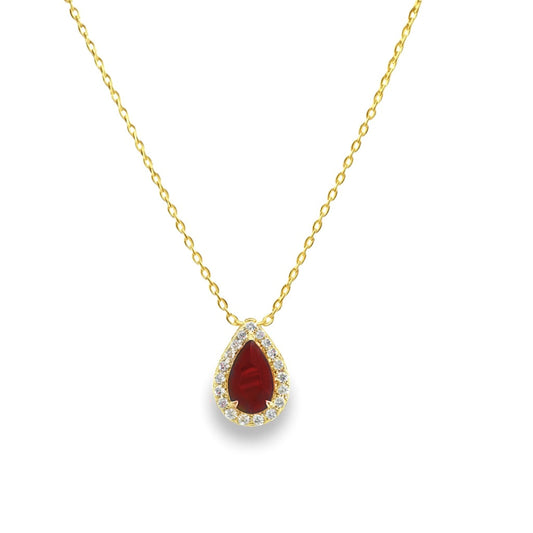 Gold necklace with a ruby gemstone pendant with diamond halo on a white background